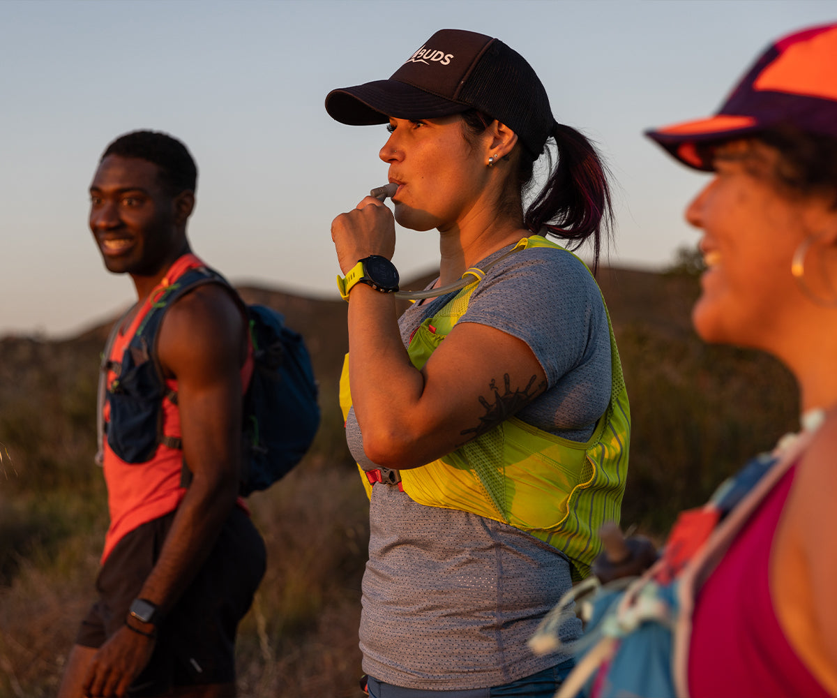 Three trail runners outside taking a break